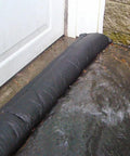 Grab And Go Flood Kit With Ten Five Foot Flood Barriers Water Activated Expands Up To Three And A Half Inches High When Wet Provides Up To Fifty Feet Of Flood Protection Per Bucket No Sand Or Labor Needed Store In Vehicle Or Closet Orange barrier blocking water at door.