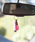 Resqme emergency escape tool, pink, on a key ring hanging from car rearview mirror.