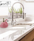 Pink Ceramic Soap Dispenser With Gold Pump For Bathroom Or Kitchen Sink, flamingo design next to chrome faucet on white countertop