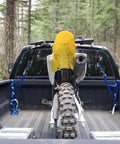Heavy Duty 6 Pack Ratchet Straps Tie Down Haulers 1 Inch X 12 Foot With S Hooks securing a dirt bike in a truck bed surrounded by trees.