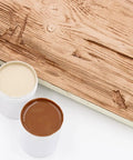 4 Oz Champagne Mist Touch Up Paint Kit For Faux Wood Beams And Trim includes beige and brown tint jars on wooden surface.