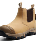 Mens 6 Inch Steel Toe Slip On Work Boots Chelsea Waterproof Safety Footwear Heavy Duty Electrical Hazard Rated Non Slip Rubber Outsole Built Tough All Day Workdays, tan color with slip-on design and sturdy rubber outsole.