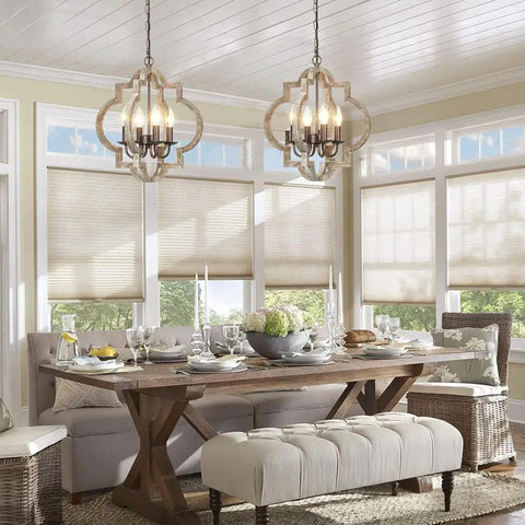 Dining room with two Orb 4 Light Farmhouse Chandeliers with handmade wood frames in bronze and walnut finish above a rustic table.