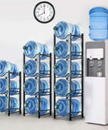 Heavy Duty 4 Tier Water Jug Rack for 5 Gallon Jugs Detachable Black Metal Bottle Holder next to water cooler