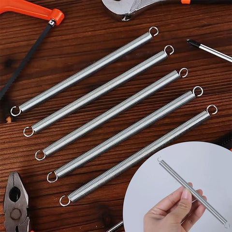 Twelve Pc Heavy Duty Mechanical Compression Springs With Hook Ends For DIY Mods And Home Repairs Made From Fatigue Resistant Spring Steel To Keep Your Gadgets Running Smooth All Day Long, displayed on wooden surface.