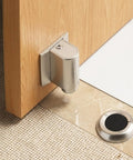 Super Heavy Duty Invisible Door Stopper With Strong Adhesive Or Screws For Solid Steel Zinc Alloy Hold Keeps Bedroom Doors Locked In Place Without Drilling Holes And Looks Sleek With Brushed Nickel Finish mounted on wooden door.