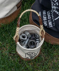 Compact Mini Tool Bucket With Leather Bottom And Reinforced Rope Handle For Small Jobs holding nuts and bolts on grass