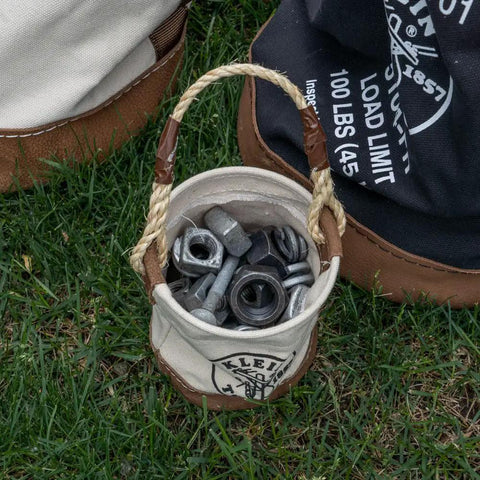 Compact Mini Tool Bucket With Leather Bottom And Reinforced Rope Handle For Small Jobs holding nuts and bolts on grass