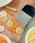 Zorveiio crinkle cutter with black handle and stainless steel blades, front view on wooden cutting board