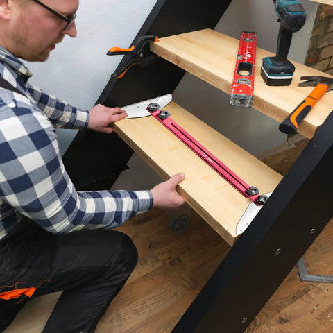 Man using Pro Grade Stair Tread Template Tool Gauge With Adjustable Range 11.4 In To 60.7 In on wooden stairs