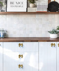 Kitchen cabinets with Gold Bow Cabinet Knobs Set Two Pack Brass Finish Bow Shaped Pulls for drawer and door handles, completed view.