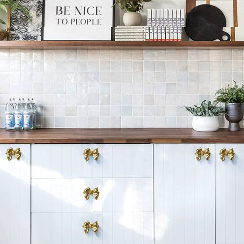 Kitchen cabinets with Gold Bow Cabinet Knobs Set Two Pack Brass Finish Bow Shaped Pulls for drawer and door handles, completed view.