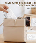 Hand placing foldable Three In One Magnetic Wireless Charger Travel Station into a beige handbag, space saver design shown