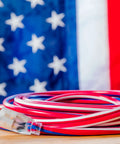 Beefy Built Tough Outdoor Extension Cord 50 Ft 12 Gauge patriotic red white and blue coiled against American flag background