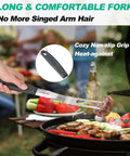 HAUSHOF stainless steel grill spatula with black ergonomic handle over a barbecue grill