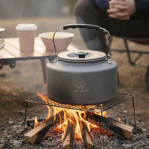 Two Point Two Liter Camping Kettle For Open Flame And Stove Fast Boil Water On The Go Lightweight Tea Pot in use over campfire.