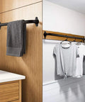 Wall-mounted black metal handrail as towel and clothing rack in bathroom and laundry spaces