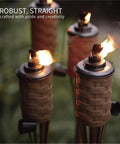 Citronella Bamboo Torches 4 Pack in Brown, 60 Inch Tall Outdoor Lighting Stakes, Weatherproof Wide Mouth Metal Canister Torches in use