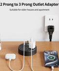 2 Prong To 3 Prong Outlet Adapter Power Strip with devices plugged in on wooden desk