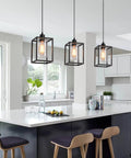 Rock Solid Black Pendant Lights For Kitchen Island, 3 Pack Sleek Industrial Farmhouse Lanterns With Adjustable Height And Clear Glass Shade above a modern kitchen island