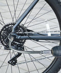 Flexible Drill Bit Extension and 105 Degree Right Angle Drill Adapters Kit in use with bicycle gears for tight corner access.