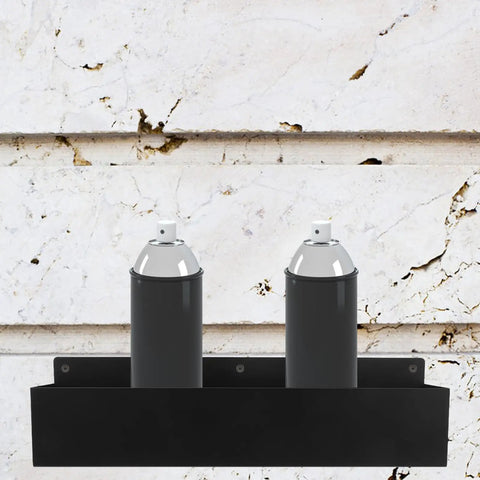 Wall Mount Spray Can Holder And Tool Rack Heavy Duty Metal Storage Shelf with two aerosol cans against stone wall background.
