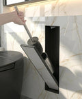 Hidden In Wall Toilet Brush Holder Cabinet in matte black with tileable door, sleek space saver bathroom organizer, 45x12x12 cm, in use.