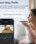 Woman using 1080p Outdoor Security Camera With Night Vision, Weatherproof, Ideal For Home Surveillance, on smartphone for 2-way audio.