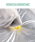 User demonstrating Heavy Duty Self Adhesive Aluminum Foil Insulation Roll's scratch-resistant quality with gloved hand.