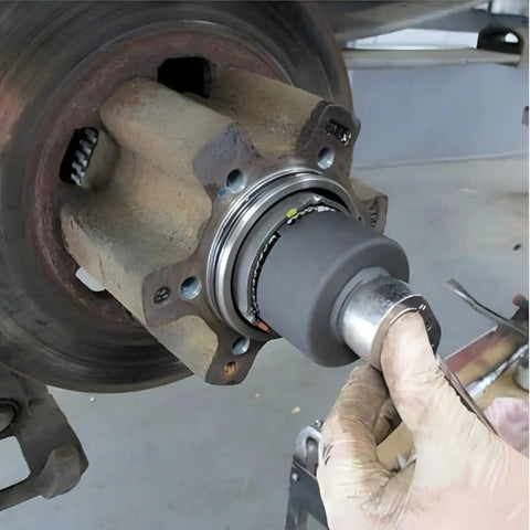 Mechanic using Ford 4 Lug Rear Axle Nut Socket Wrench For F Series Trucks Ten And A Half Inch Spindle Nut Size Two And Three Quarter Inch