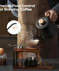 Gooseneck Electric Kettle With Precision Temperature Control Within One Degree Fahrenheit 1200W Rapid Boil In Five Minutes Keeps Warm Six Hours 304 Stainless Interior BPA Free Black pouring hot water over coffee.