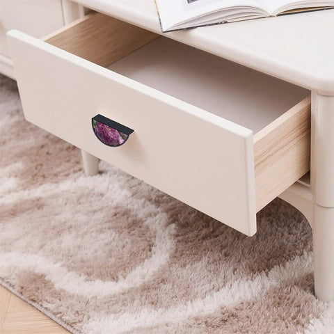 Open drawer with 2 Pack Botanical Peony Cabinet Handles in black, semicircle design, on beige cabinet.