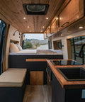 Interior of a camper van with wooden accents, showcasing the Ultra Slim 12V Led Ceiling Puck Light with Sweet Dimming Controls.