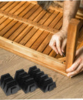 Person assembling wooden furniture with Modular Wrench Organizer Rack 12-Piece Plastic Tool Storage Tray nearby on floor