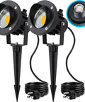 Two-pack outdoor LED spotlight with dusk to dawn sensor, 20W 2000 lumen, 3000K warm white, waterproof, 6 ft cord, spiked stand.