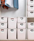 Erasable Label Holders Kit With 20 White PVC Bin Clips And 2 Chalk Markers used on storage bins labeled Towel, Tops, Pants
