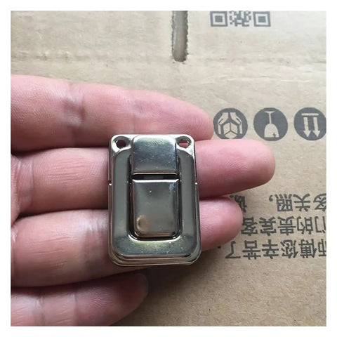 Person holding Sturdy Iron Box Hasps Set Of 10 Latches With Antique Bronze Finish And Gold Tone Built To Last, close-up view.
