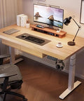 Top Notch Adjustable Standing Desk With Roomy Hidden Storage Drawers And No Sweat Preset Height Adjustments Featuring Built In Headphone Hook And Clean Natural Wood Finish For Solid Home Office Workstations, viewed from above with accessories.