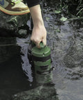 Person using 1HP Submersible Sump Pump With 3500GPH For Clean Or Dirty Water Built In Float Switch And Carry Handle in pond
