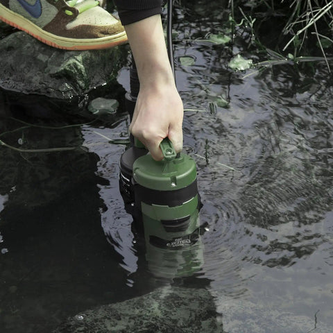 Person using 1HP Submersible Sump Pump With 3500GPH For Clean Or Dirty Water Built In Float Switch And Carry Handle in pond