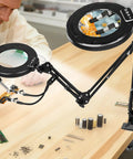 Pro Grade 12X 30X Magnifying Glass With Light And Clamp showing swing arm and LED light over electronic components on desk.