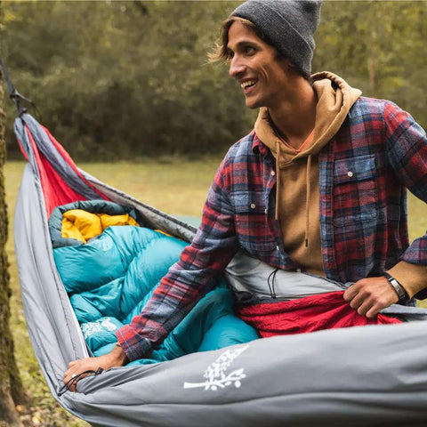 Person adjusting Ultralight Hammock Underquilt Insulated Camping Quilt For Warm Sleep Under Your Hammock Water Resistant Packable And Durable