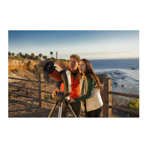 Couple using NexStar 6SE Computerized Telescope Bundle With Eyepiece And Filter Accessory Kit For 1.25 Inch Optics at seaside.