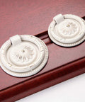 European Style Drop Ring Pull Handles for Cabinets and Drawers Lotus Pattern Knobs 2.2 Inch Diameter Zinc Alloy on wood surface