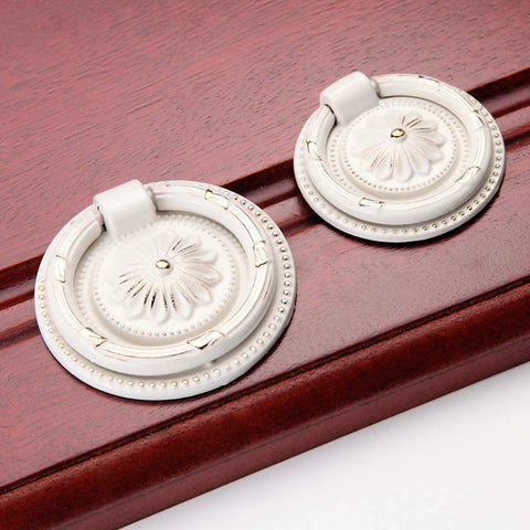 European Style Drop Ring Pull Handles for Cabinets and Drawers Lotus Pattern Knobs 2.2 Inch Diameter Zinc Alloy on wood surface