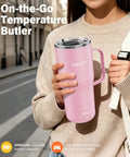 Self Heating Coffee Mug 20oz Electric Temp Control Warmer Keeps Your Brew Piping Hot With Three Rad Heat Settings Zero Room For Cold Swigs Perfect For Office Grind Or Backroad Adventures Rechargeable Design held by woman in pink, outdoors, with cup holder design.