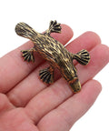 Vintage Brass Duckbill Cabinet Door Pull Handle Single Hole Design with animal shape on a hand