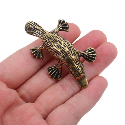 Vintage Brass Duckbill Cabinet Door Pull Handle Single Hole Design with animal shape on a hand