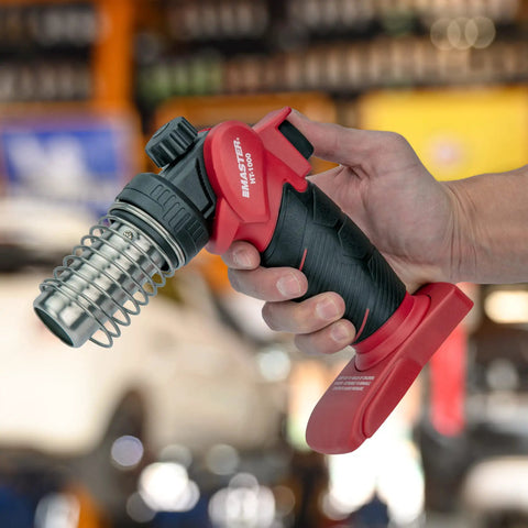 Person holding Cordless Butane Heat Gun With Shrink Reflector, Refillable Portable Hot Air Tool for repairs