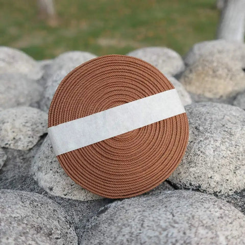 Pro Grade Synthetic Silk Tsuka Ito Wrapping Cord 22.9ft roll for katana on stone surface